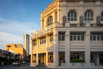 a white building with a sign on the side of it at The George Penang by The Crest Collection in George Town