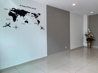 a map of the world on a wall in an empty room at Hotel Mutiara in Gua Musang