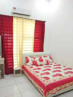 a bedroom with a bed and a red curtain at Tuah Homestay Musleem Only in Chemor