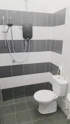 a bathroom with a toilet and a shower at Tuah Homestay Musleem Only in Chemor