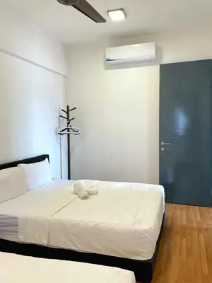 a bedroom with a large white bed with a blue door at Timeless, 3BR Cityview by WStay @ Tropicana 218 Macalister in George Town