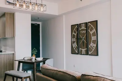 a living room with a couch and a clock on the wall at Timeless, 3BR Cityview by WStay @ Tropicana 218 Macalister in George Town