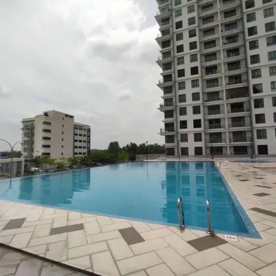 a large swimming pool in front of two tall buildings at 191 Cozy Casa Kayangan 3BR 6pax by Grab A Stay in Ipoh