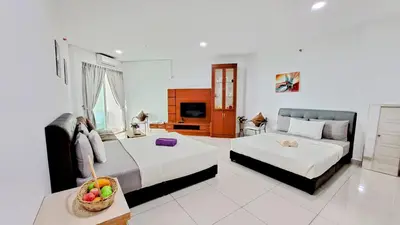 a hotel room with two beds and a television at Mansion One Entire House 4 QueenBeds - Spacious Balcony Seaview in George Town