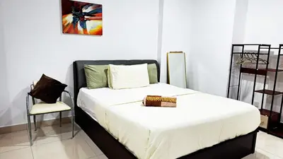 a bedroom with a white bed and a chair at Mansion One Entire House 4 QueenBeds - Spacious Balcony Seaview in George Town