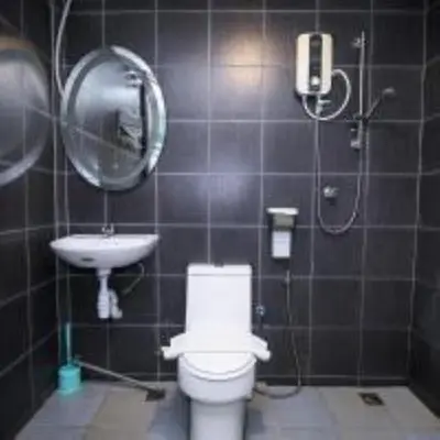 a bathroom with a toilet and a sink at Swing & Pillows @ Beach Street in George Town