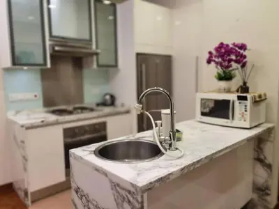 a kitchen with a sink and a microwave at WHITE HOUSE STRAITS QUAY MARINA LUXURY STAY GURNEY in Tanjong Tokong