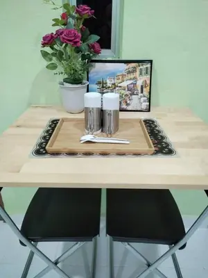 a table with a tray with a napkin and two mugs at Inap Desa 1 in Kampong Siput