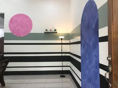 a room with black and white stripes and a surfboard at Koolest homestays Meru in Ipoh