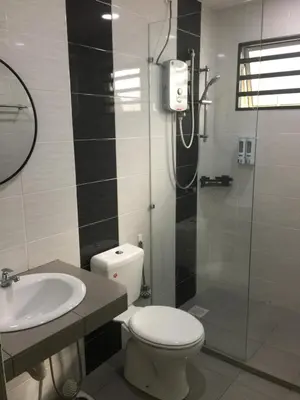 a bathroom with a shower and a toilet and a sink at Koolest homestays Meru in Ipoh