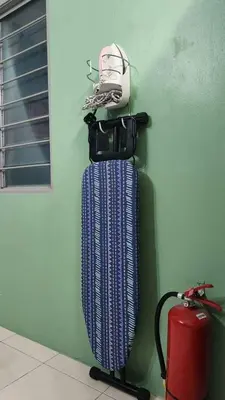 a wall with a suitcase hanging on a wall at Homestay De Mutiara Tasek Ipoh in Ipoh
