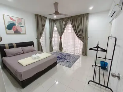 a bedroom with a bed with two towels on it at D’sayang homestay klebang ipoh in Ipoh