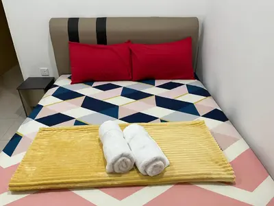 a bedroom with a bed with towels on it at D’sayang homestay klebang ipoh in Ipoh