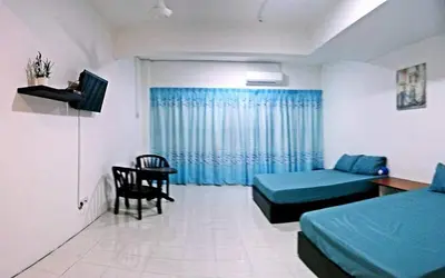 a room with two beds and a couch and a table at “Alan Homestay” Pangkor Lot 10 in Kampong Sungai Udang