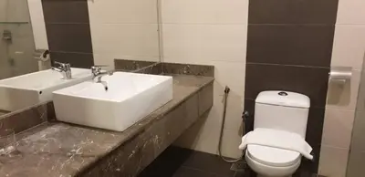 a bathroom with a white sink and a toilet at MyDream Guest House in Ipoh