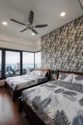 a bedroom with two beds and a ceiling fan at New Georgetown Tropical Macalister 218 Homestay 9pax to11pax HENG in George Town