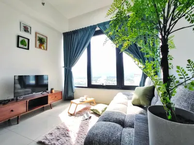 a living room with a couch and a potted tree at New Georgetown Tropical Macalister 218 Homestay 9pax to11pax HENG in George Town
