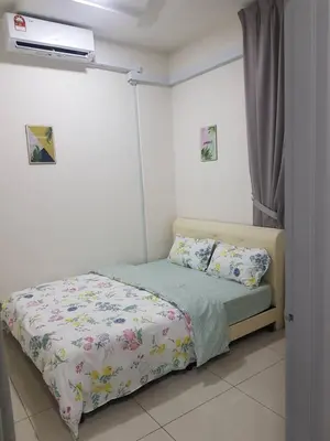 a small bedroom with a bed with avertisement at D' Homestay Meru Ipoh - Free WiFi in Ipoh