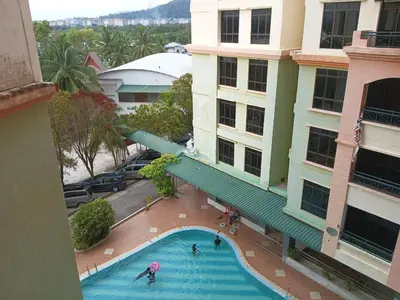 an overhead view of a swimming pool in front of a building at My Getaway Home @Marina Cove in Lumut