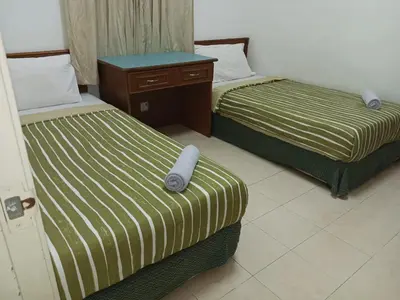 two beds sitting next to each other in a room at My Getaway Home @Marina Cove in Lumut