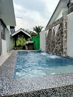 a swimming pool in front of a house at Rumah Hana Sungai Besar - Mslim0nly in Sungai Besar