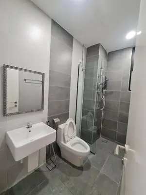 a bathroom with a toilet and a sink and a shower at The Cove Hillside Condominium in Ipoh