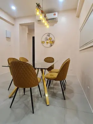 a dining room with a table and chairs at The Cove Hillside Condominium in Ipoh