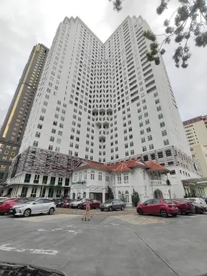 a large white building with cars parked in a parking lot at Exclusive Studio/ 1~4pax/ Gurney/ Mansion One in George Town