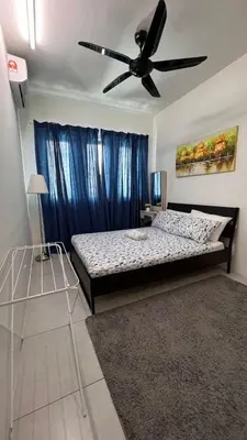 a bedroom with a bed and a ceiling fan at D Naurah Meritus Guesthouse in Perai