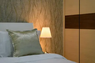 a lamp sitting next to a bed in a bedroom at 2R1B/Seaview Tropical /1~8Pax/Gurney Mansion One in George Town