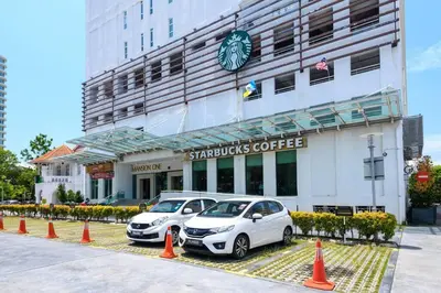 two white cars parked in front of a building at 2R1B/Seaview Tropical /1~8Pax/Gurney Mansion One in George Town