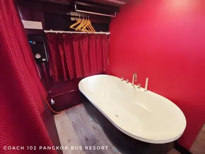 a bathroom with a white sink in a red wall at Pangkor Bus Resort by BESLA in Pangkor