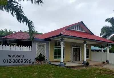 a small yellow house with a red roof at Villa Auliyya - MusleemHomestay in Kampong Sungai Leman