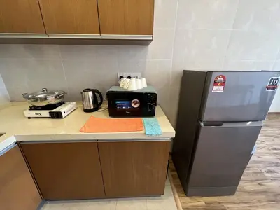a kitchen with a counter with a toaster and a refrigerator at NEW 6pax 3BR Sunrise view 100m Attractive Places Kea Farm in Cameron Highlands