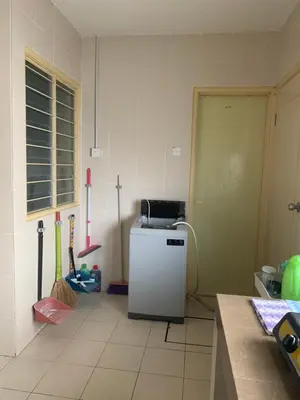 a kitchen with a small refrigerator in a room at ZillQayyim Homestay in Seri Iskandar