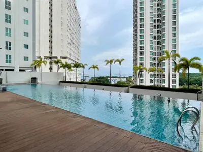 a swimming pool in the middle of two tall buildings at Pool View Stylish Suite at Jelutong Penang 1-4pax in George Town
