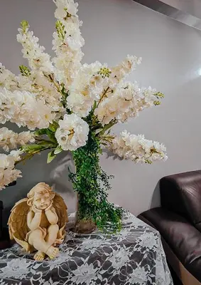a vase filled with white flowers on top of a table at Ipoh Town Kinta Riverfront Apartment 7pax by Glamorous in Ipoh