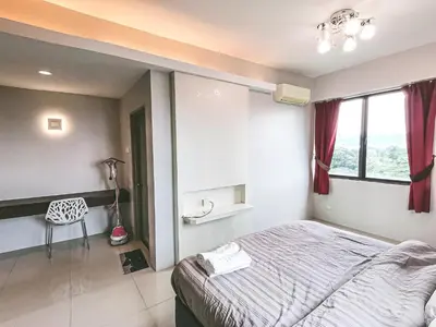 a bedroom with a bed and a chair in it at Ipoh Town Kinta Riverfront Apartment 7pax by Glamorous in Ipoh