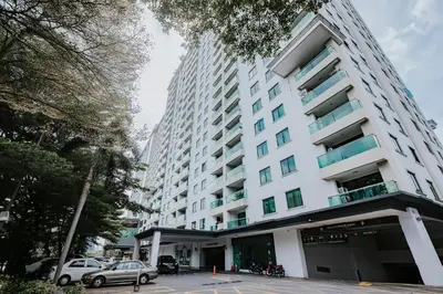 a large white building with cars parked in front of it at Ipoh Town Kinta Riverfront Apartment 7pax by Glamorous in Ipoh