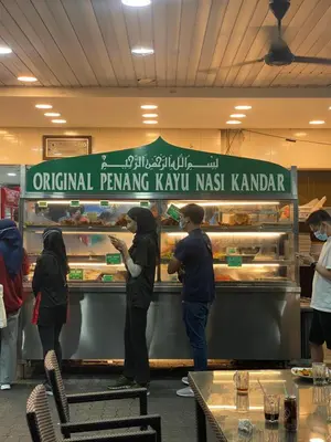 a group of people preparing food in a bakery at NEW 6 PAX SUITE near USM and SPICE ARENA and AIRPORT in Bayan Lepas