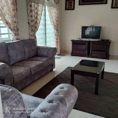 a living room with a couch and a tv at Zulkifli Homestay Tambun,Ulu kinta,Tg Rambutan in Ipoh