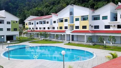 a hotel with a swimming pool in front of a building at Pangkor Pasir Bogak Apartment 2Rooms 2Bathrooms near beach 6pax FREE WIFI in Pangkor