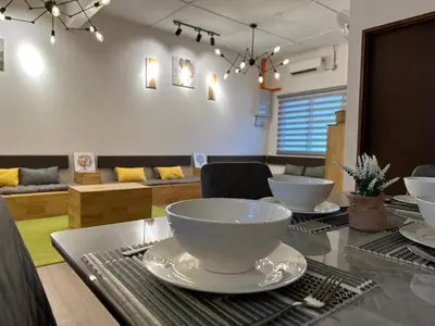 a dining room with a table with bowls on it at Ipoh Family Masjid Muhammadiah Evicharger SY15 in Ipoh