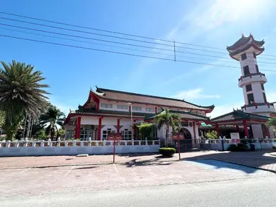 a building with a clock tower on a street at Ipoh Family Masjid Muhammadiah Evicharger SY15 in Ipoh
