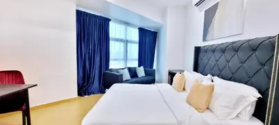 a hotel room with a bed and a chair at RENTIO HOTEL in Kulim
