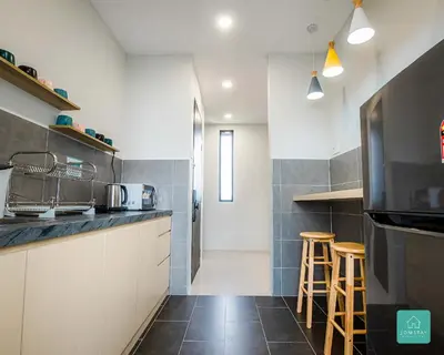 a kitchen with a counter and some stools in it at Jomstay The Cove Ipoh Hillside Residence in Ipoh