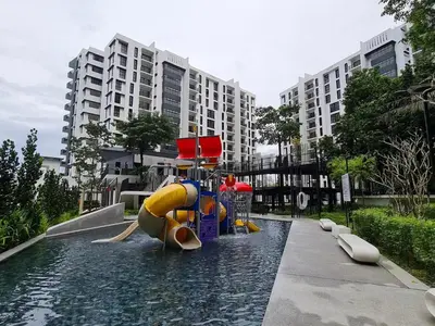 a water slide in the middle of a swimming pool at Jomstay The Cove Ipoh Hillside Residence in Ipoh