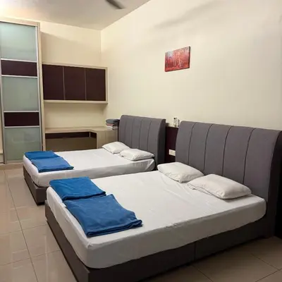a room with three beds with blue towels on them at 15PAX 3 BR, Kids Swimming Pool, Pool table, BBQ near Spice ARENA, Airport Penang in Bayan Lepas