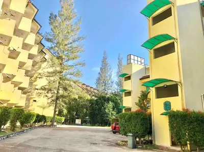 a building with a parking lot in front of it at Natural Paradise 3Mins to Beach at Teluk Batik Lumut in Lumut