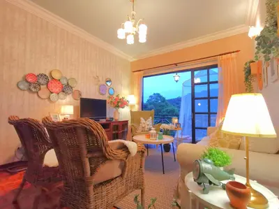 a living room with a couch and chairs and a table at Green Hill Apartment in Tanah Rata